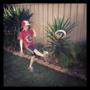 Caleb Kicking a Football with Rory Sloane